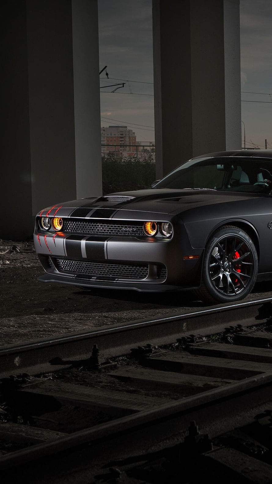 2019 Dodge Challenger SRT Hellcat with red accents parked on railway tracks under an overpass HD phone wallpaper