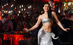 Kareena Kapoor in a silver sequined outfit performing on a stage with a lively crowd HD wallpaper