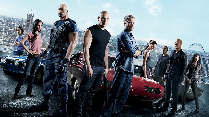 Fast and Furious ensemble cast standing with classic muscle cars against a London skyline backdrop HD wallpaper