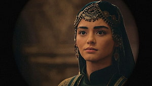 Özge Törer as Bala Hatun in ornate medieval headpiece and dark green attire HD wallpaper