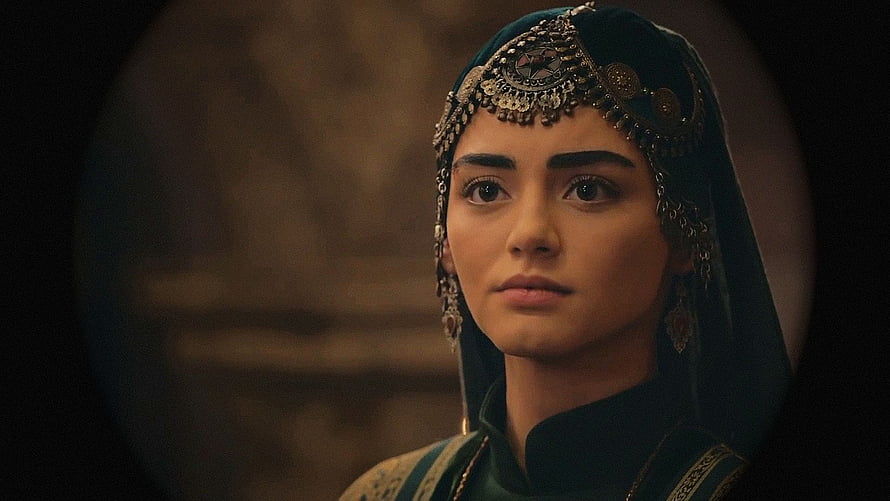 Özge Törer as Bala Hatun in ornate medieval headpiece and dark green attire HD wallpaper