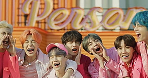 BTS Members Singing Together in Vibrant Pink Outfits HD wallpaper