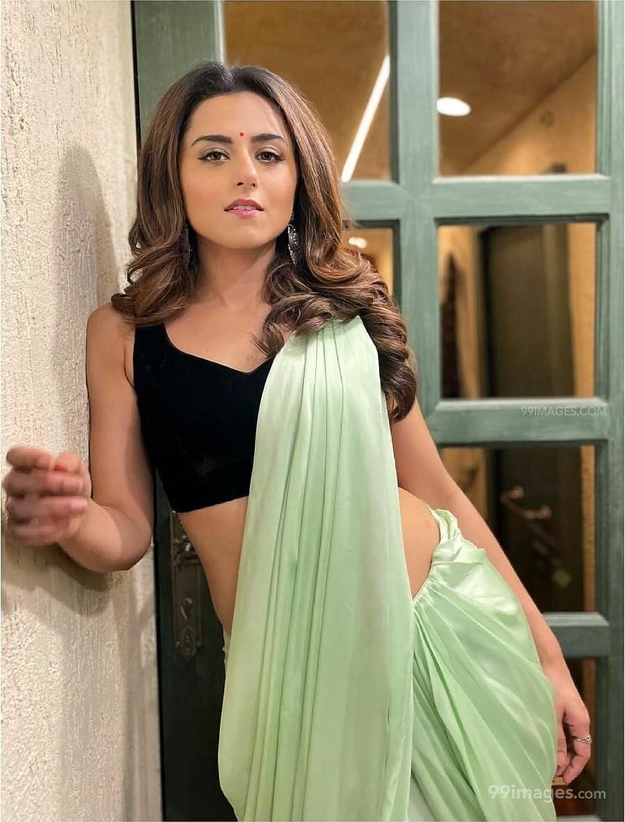 Ridhi Dogra in a mint green saree and black crop top posing by a doorway HD phone wallpaper
