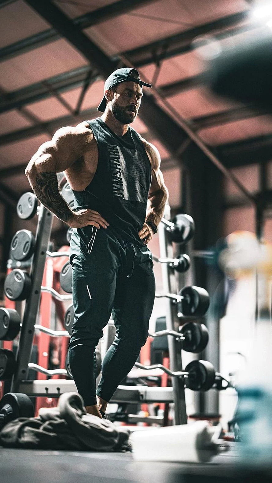 Muscular Man in Gymshark Tank Top Standing in Weight Room HD phone wallpaper