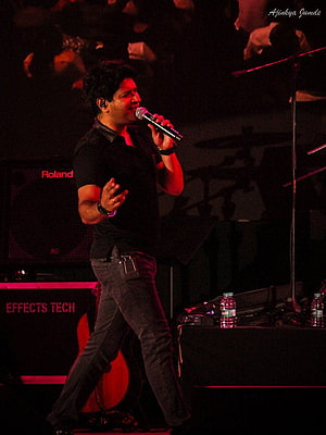 KK Live Concert Performance on Stage with Microphone and Red Lighting HD phone wallpaper