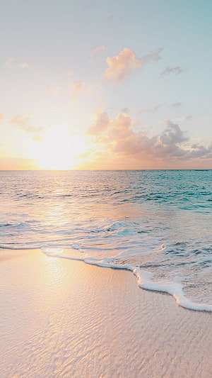 Serene Ocean Sunset Over White Sand Beach With Gentle Waves And Soft Golden Light HD phone wallpaper