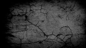 Dark Cracked Stone Texture with Deep Fissures and Grunge Surface Details HD wallpaper