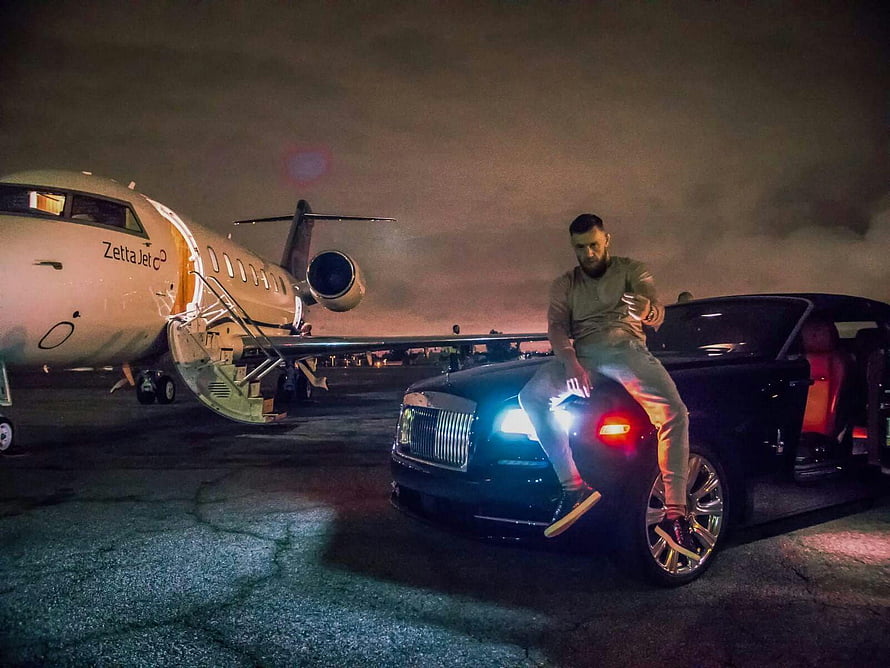 Conor McGregor Sitting On A Black Rolls Royce Next To A Private Jet At Night HD wallpaper