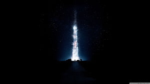 Interstellar Galaxy Core Rising Over Silhouetted Horizon at Night HD wallpaper