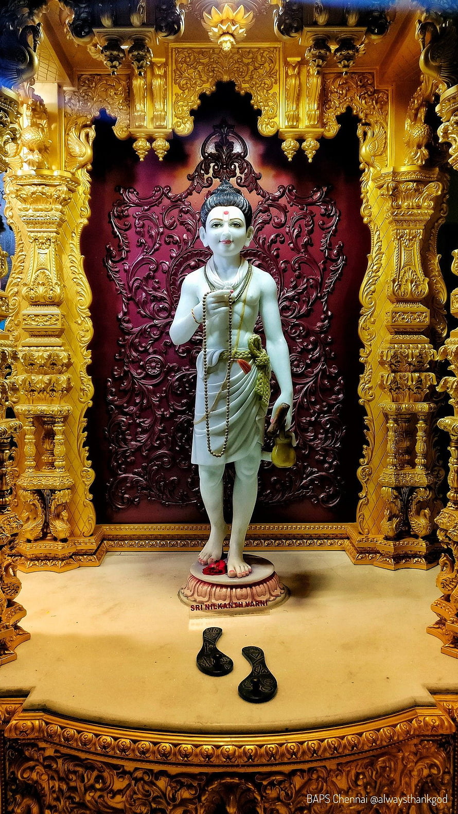 Nilkanth Varni Maharaj Statue in Ornate Golden Temple Shrine with Intricate Carvings HD phone wallpaper