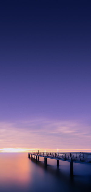 Serene Ocean Pier at Twilight with Soft Purple and Pink Gradient Sky HD phone wallpaper