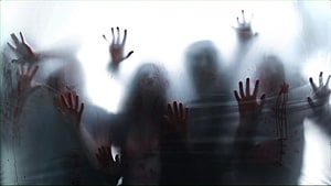 Horror Scene of Blood-Stained Hands Pressed Against Frosted Glass HD wallpaper