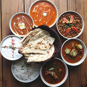 Traditional North Indian Thali Platter with Naan, Rice, and Multiple Curries HD phone wallpaper