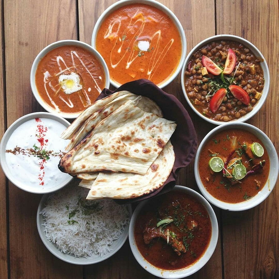 Traditional North Indian Thali Platter with Naan, Rice, and Multiple Curries HD phone wallpaper