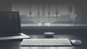 Minimalist Workspace Setup With Laptop, Keyboard, and Mouse on Dark Desk HD wallpaper
