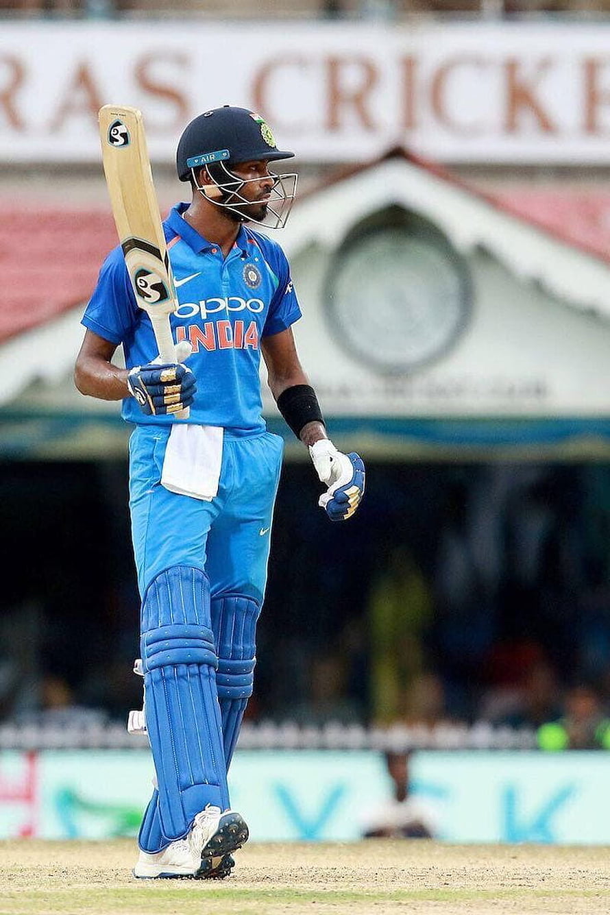 Hardik Pandya in India ODI kit walking on the cricket field with bat and pads HD phone wallpaper
