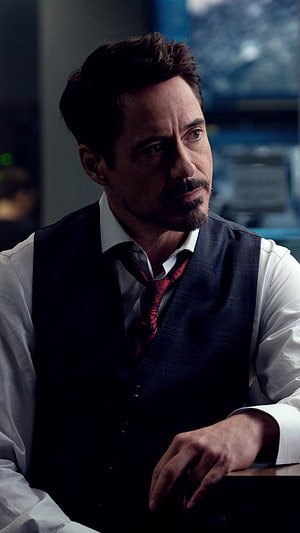 Robert Downey Jr as Tony Stark in a dark vest and red tie with a serious expression HD phone wallpaper