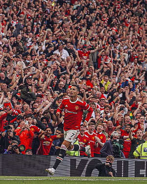 Cristiano Ronaldo Celebrating a Goal in Manchester United Red Kit Before a Roaring Crowd HD phone wallpaper