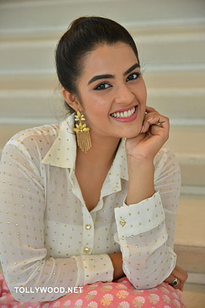 Kavya Thapar smiling portrait in white polka dot blouse with gold floral earrings HD phone wallpaper