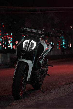 KTM Duke 250 Motorcycle at Night with Glowing Headlights and Bokeh City Lights HD phone wallpaper