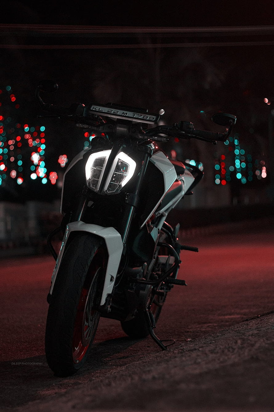 KTM Duke 250 Motorcycle at Night with Glowing Headlights and Bokeh City Lights HD phone wallpaper