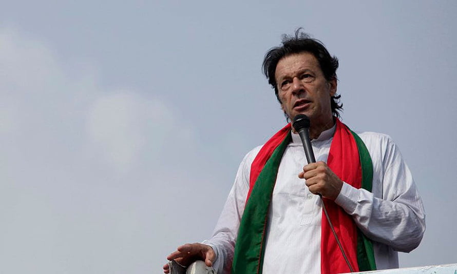 Imran Khan Speaking Into Microphone Wearing Red And Green Scarf Against Overcast Sky HD wallpaper