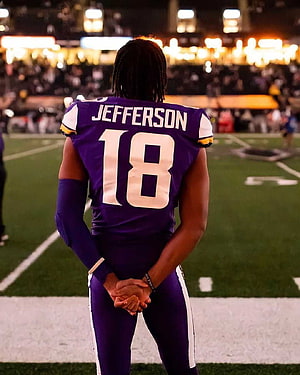 Justin Jefferson in Minnesota Vikings Purple Jersey Standing on the Football Field HD phone wallpaper