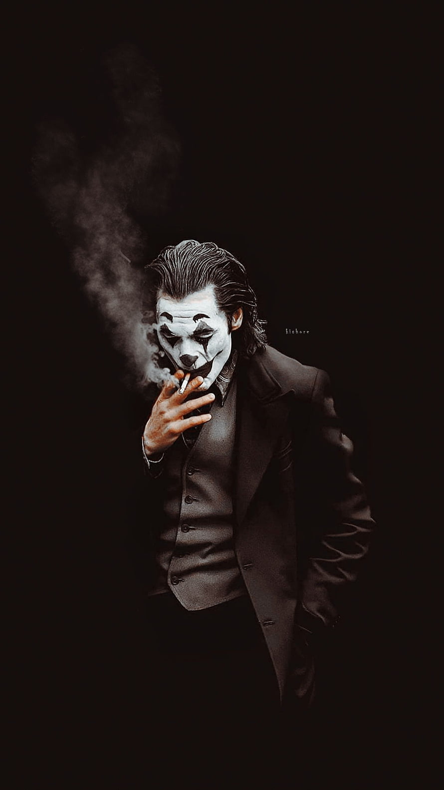 Joker in a dark suit smoking a cigarette with dramatic smoke against a black background HD phone wallpaper