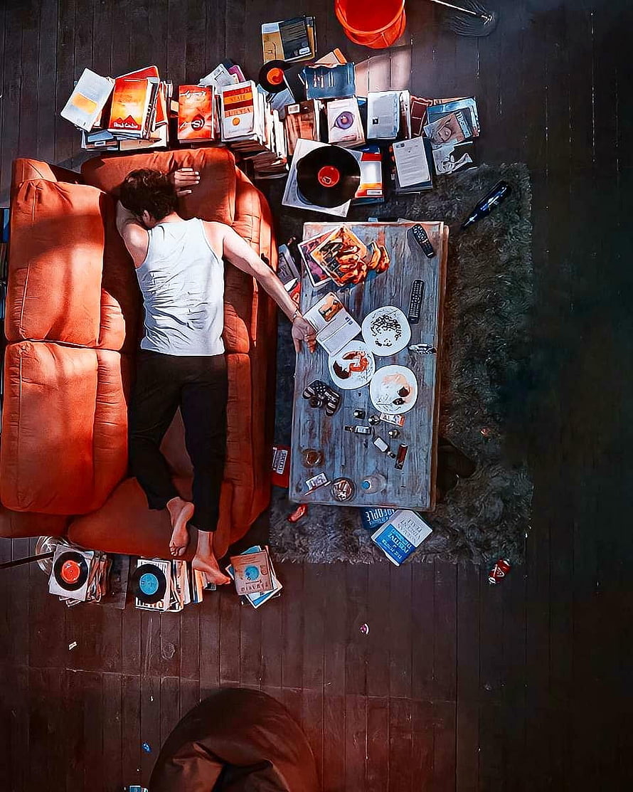 Thalapathy Vijay Reclining on Orange Sofa Amidst Vinyl Records and Books in Master Film Scene HD phone wallpaper