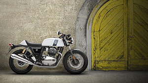 Royal Enfield Continental GT 650 Cafe Racer Motorcycle Parked Against Rustic Yellow Door HD wallpaper