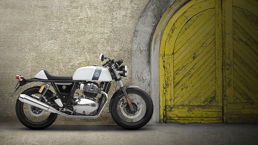 Royal Enfield Continental GT 650 Cafe Racer Motorcycle Parked Against Rustic Yellow Door HD wallpaper