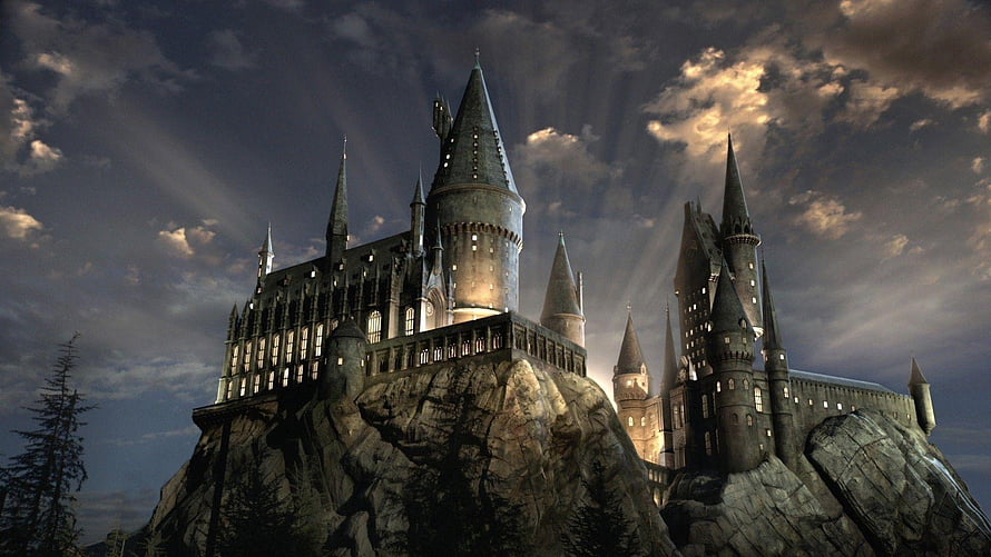 Hogwarts Castle at Dusk with Dramatic Clouds and Sunbeams HD wallpaper