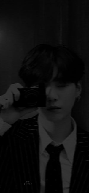 Min Yoongi in a dark pinstripe suit holding a compact camera in a moody black and white portrait HD phone wallpaper