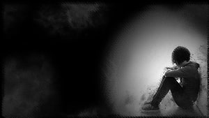 Emotional Boy Sitting Alone in a Dark Corner with Moody Black and White Atmosphere HD wallpaper