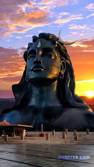 Isha Adiyogi Bust Statue at Sunset with Dramatic Orange Sky HD phone wallpaper