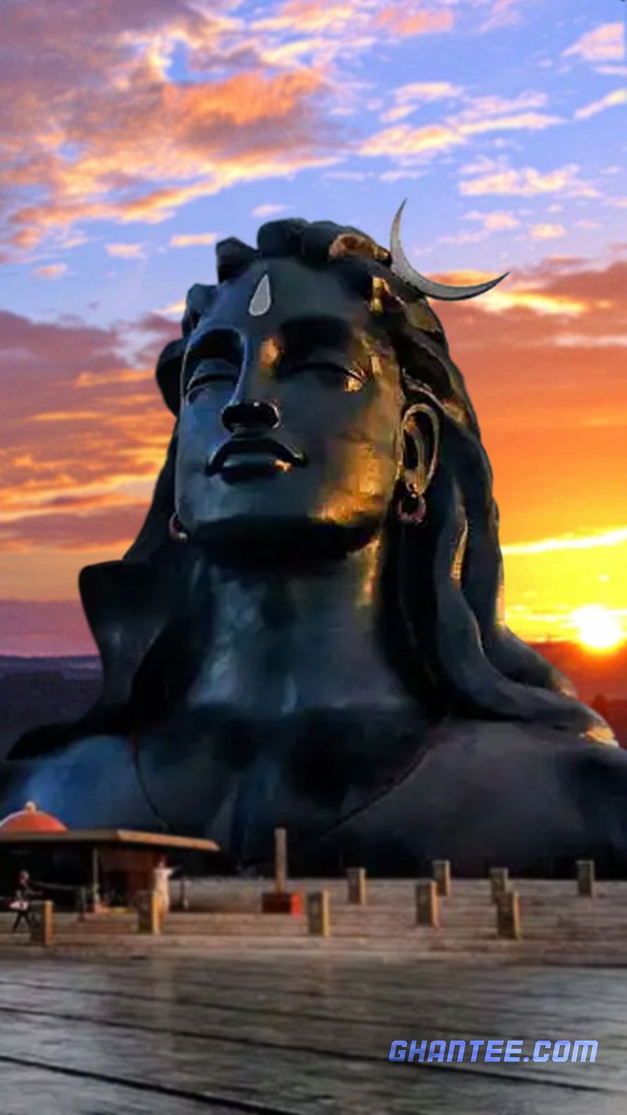 Isha Adiyogi Bust Statue at Sunset with Dramatic Orange Sky HD phone wallpaper