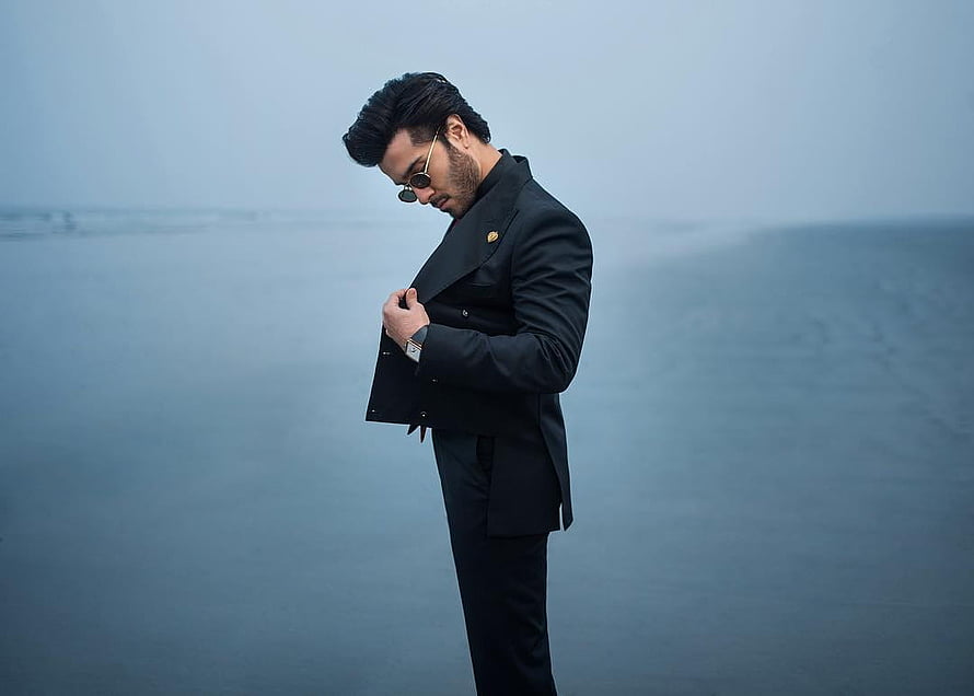 Feroze Khan in a black suit and sunglasses standing on a misty beach HD wallpaper