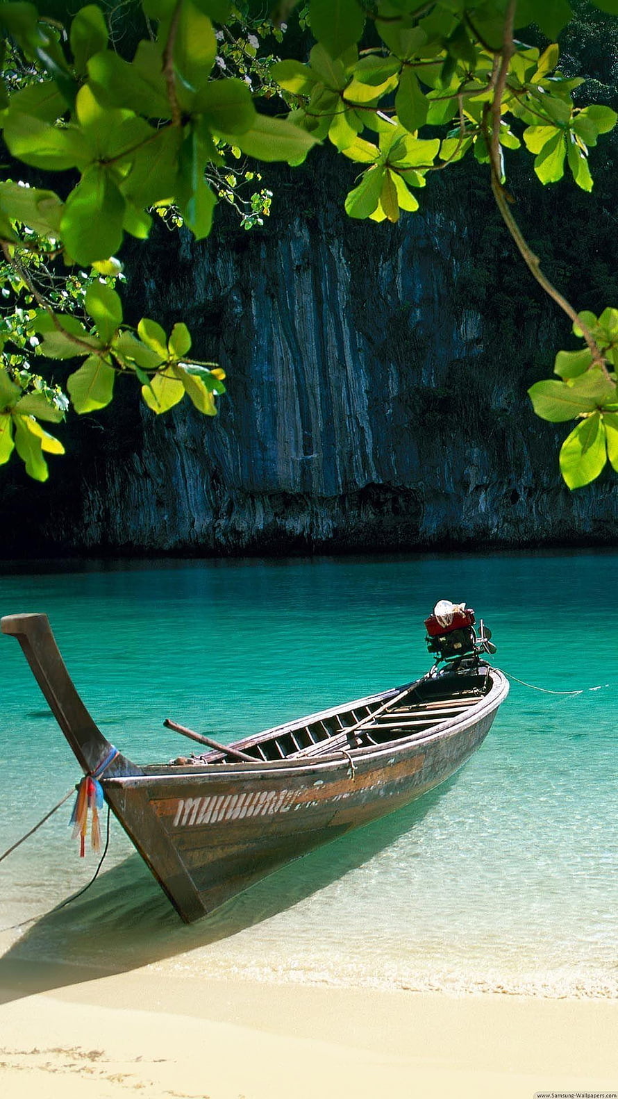 Traditional Thai Longtail Boat Moored on Turquoise Tropical Beach with Lush Green Foliage HD phone wallpaper