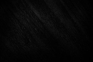 Dark Textured Black Surface with Subtle Diagonal Grain Pattern HD wallpaper