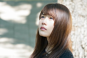 Kasumi Arimura in a contemplative outdoor portrait with soft natural lighting HD wallpaper