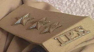 Close-up of Indian Police Service shoulder insignia with three stars and IPS badge on khaki uniform HD wallpaper