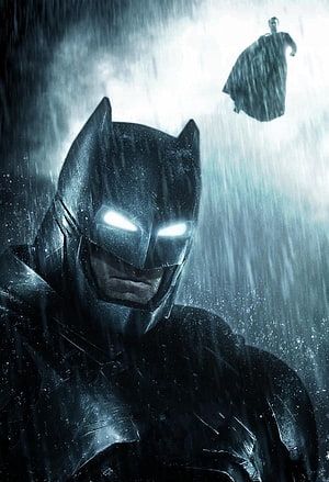 Batman in Heavy Rain with Glowing Eyes and Superman Silhouette in the Distance HD phone wallpaper