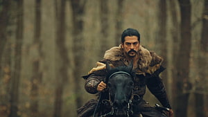 Kurulus Osman warrior riding a black horse through a misty forest in medieval armor HD wallpaper
