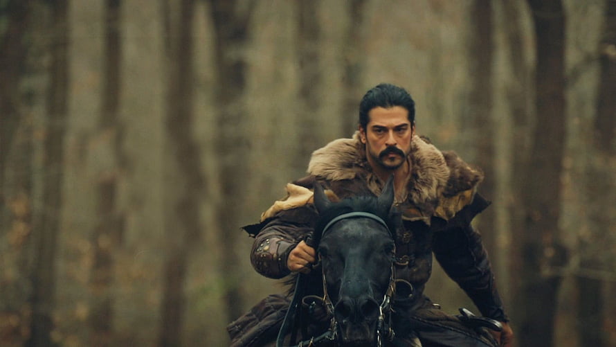 Kurulus Osman warrior riding a black horse through a misty forest in medieval armor HD wallpaper