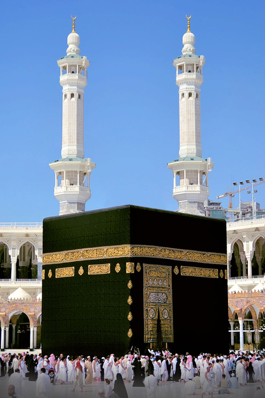 The Kaaba in Mecca with pilgrims and minarets under a clear blue sky HD phone wallpaper