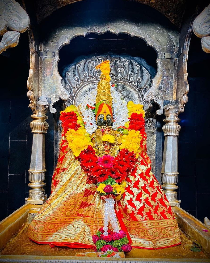 Tulja Bhavani Murti Adorned in Red and Gold Silk with Vibrant Flower Garlands in Temple Sanctum HD phone wallpaper