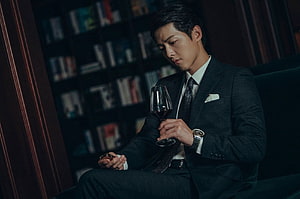Song Joong Ki as Vincenzo Cassano in a dark library holding a glass of red wine HD wallpaper