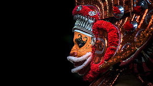 Theyyam Muthappan Performance Mask with Intricate Red and Gold Ornamentation HD wallpaper