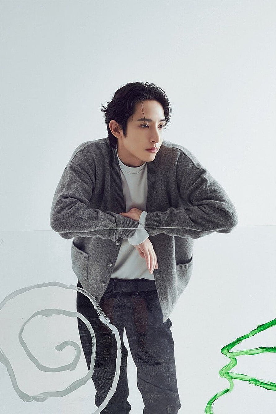 Lee Soo Hyuk in a grey cardigan and white tee posing against a minimalist white studio backdrop HD phone wallpaper