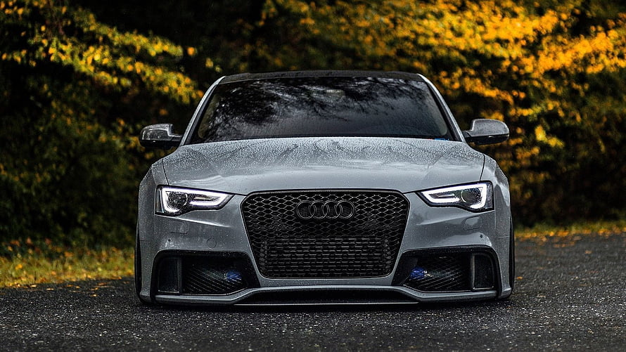 Front View of a Grey Audi S4 Sedan on a Wet Road with Autumn Foliage HD wallpaper